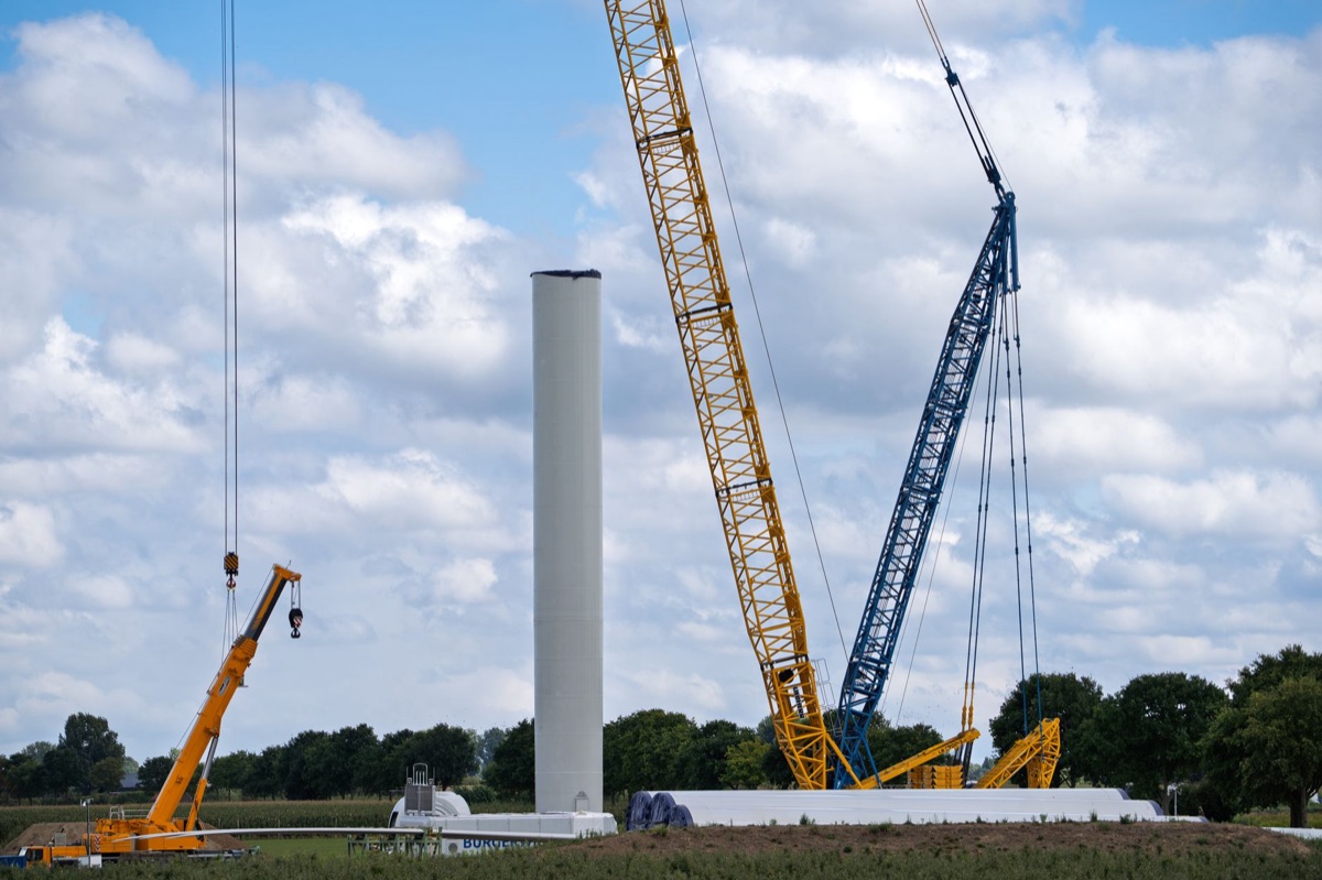 Construction site for a hybrid solar-wind energy project with scaffolding and machinery